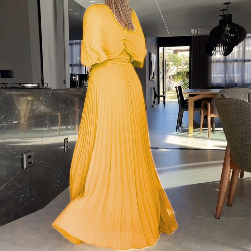 Stylish women's evening dress in black, highlighting a maxi length and unique cape sleeves.