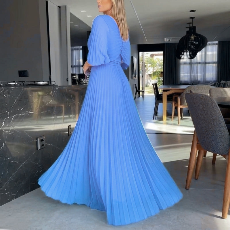Elegant women's maxi dress in black, detailed with pleats and graceful cape sleeves.