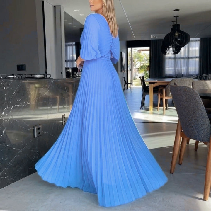 Elegant women's maxi dress in black, detailed with pleats and graceful cape sleeves.