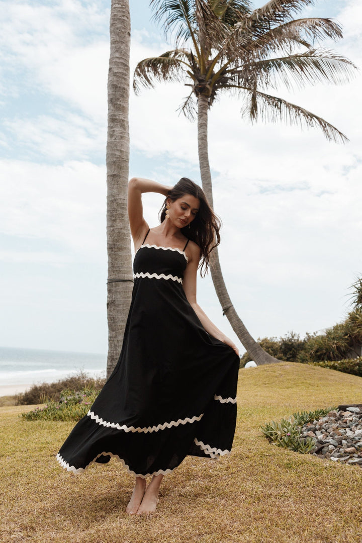 Chic sleeveless black maxi dress with delicate straps, perfect for effortless summer fashion & vacation.