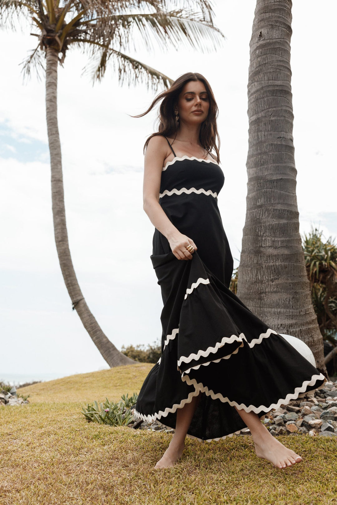 Flowy black women's maxi dress with spaghetti straps, a versatile choice for elegant or casual wear.