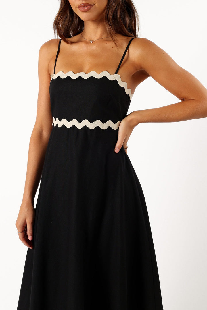 Effortless summer black maxi dress with slim straps, a timeless piece for women's resort outfits.