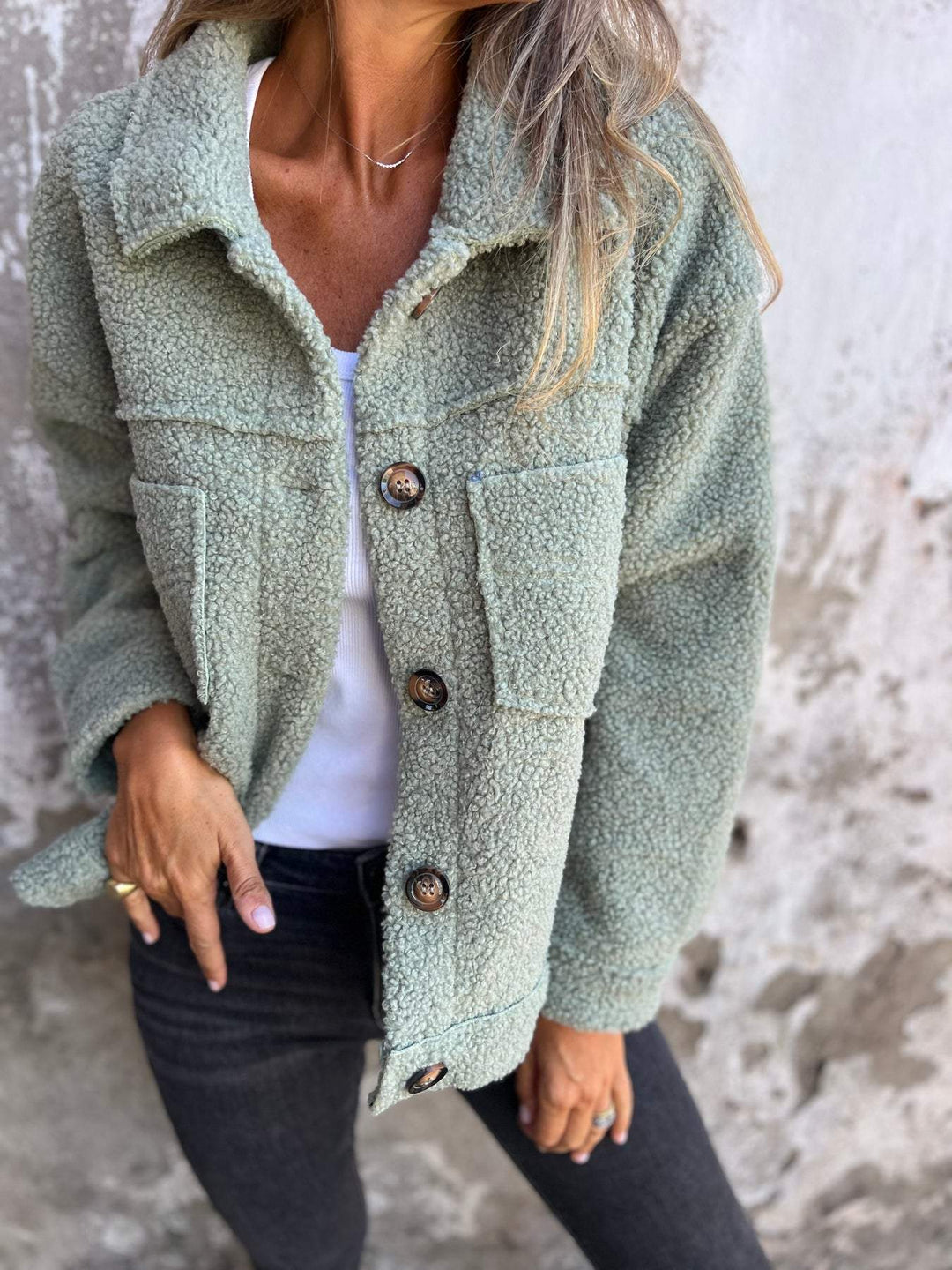 Stylish black women's winter jacket. Elegant long sleeve outerwear with button details, cozy for fall/winter.