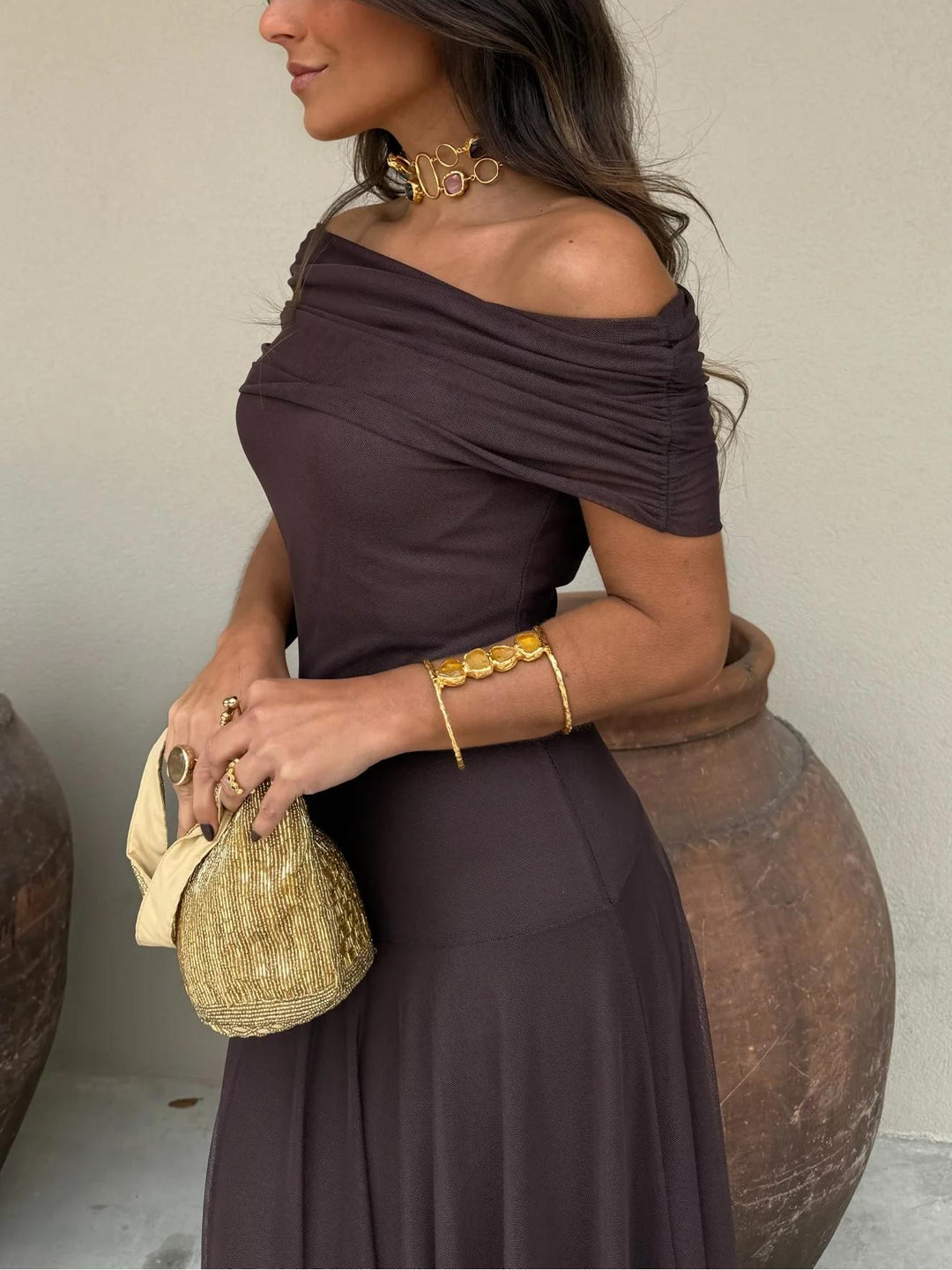 Graceful brown off-shoulder maxi dress, an elegant choice for formal events.