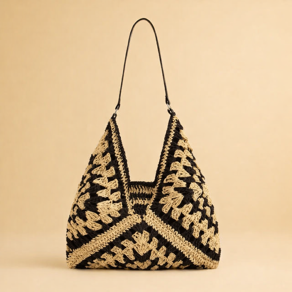 Close-up of a women's chic bohemian shoulder bag, showcasing its elegant woven texture and design.