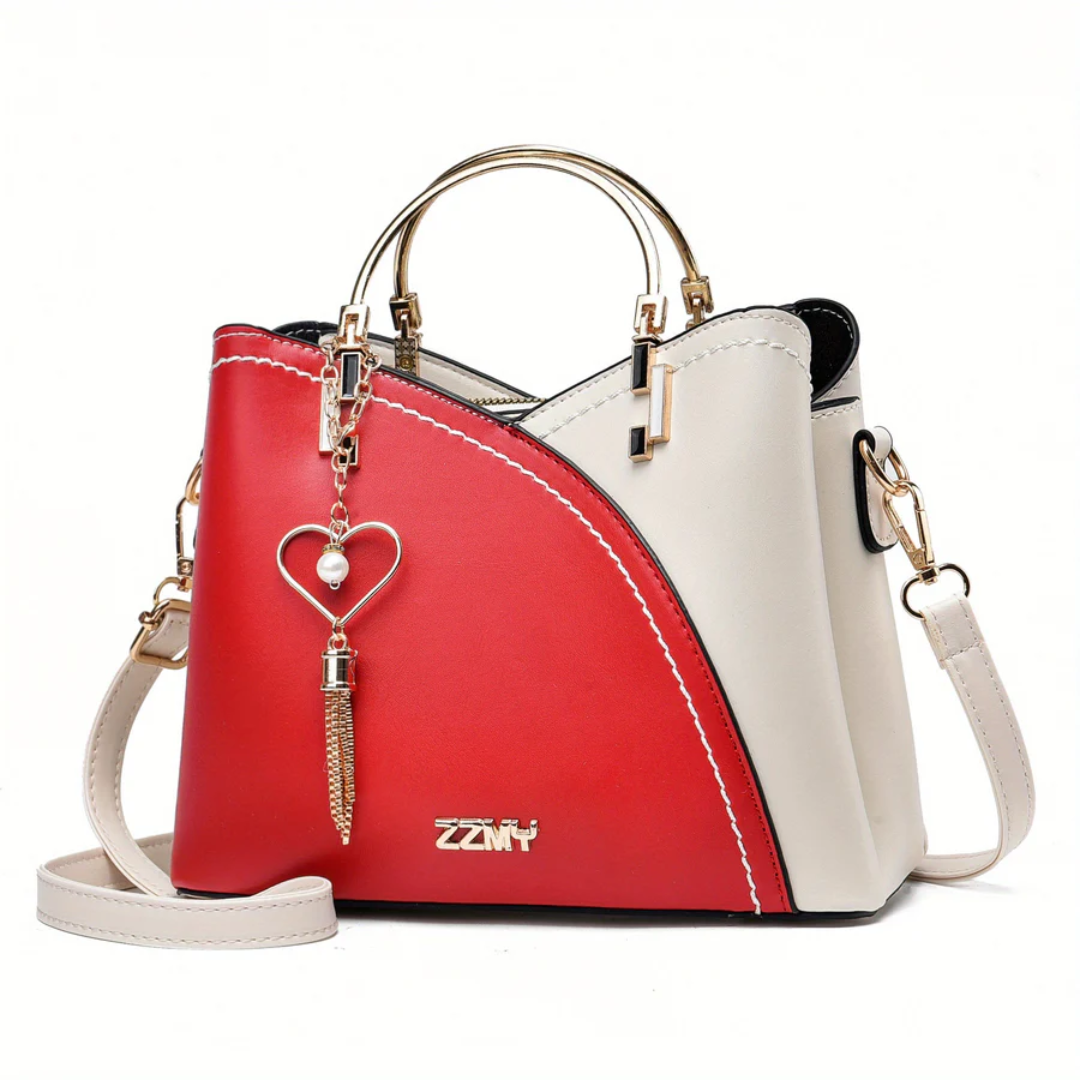 Close-up on elegant faux leather texture and hardware of women's shoulder bag.