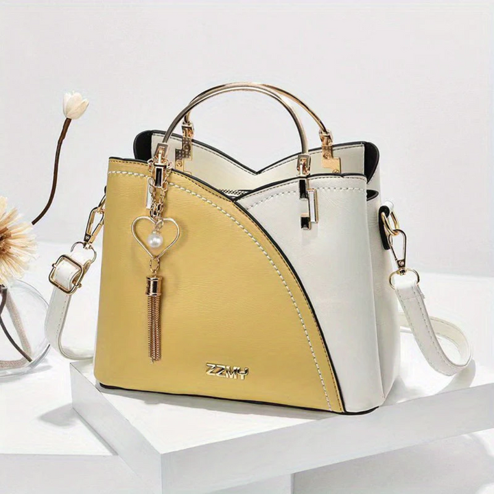 Elegant women's faux leather tote bag with long adjustable shoulder strap.