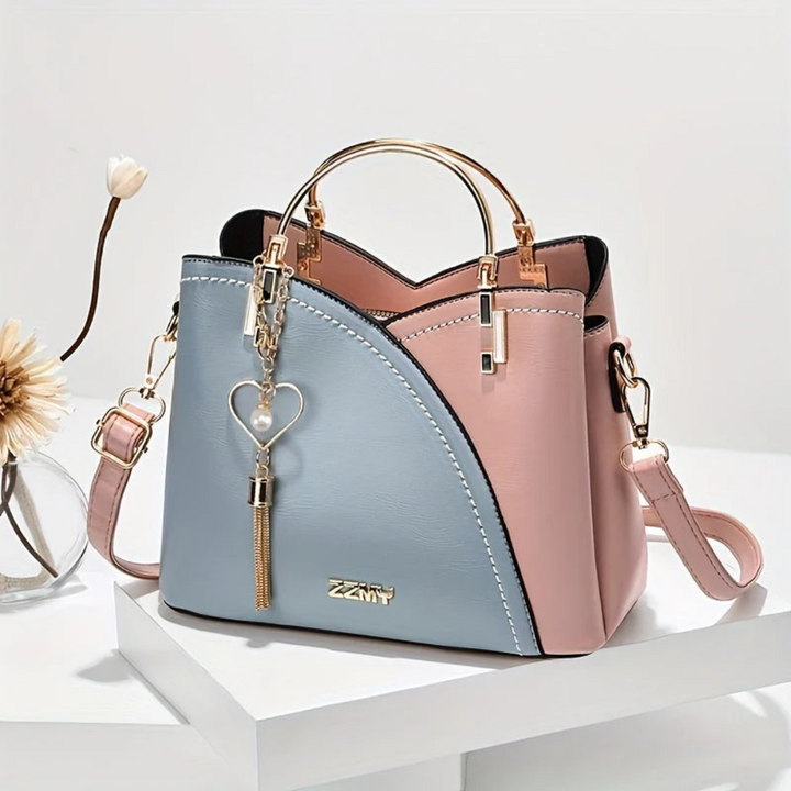 Sophisticated women's elegant faux leather handbag, featuring high-quality details.