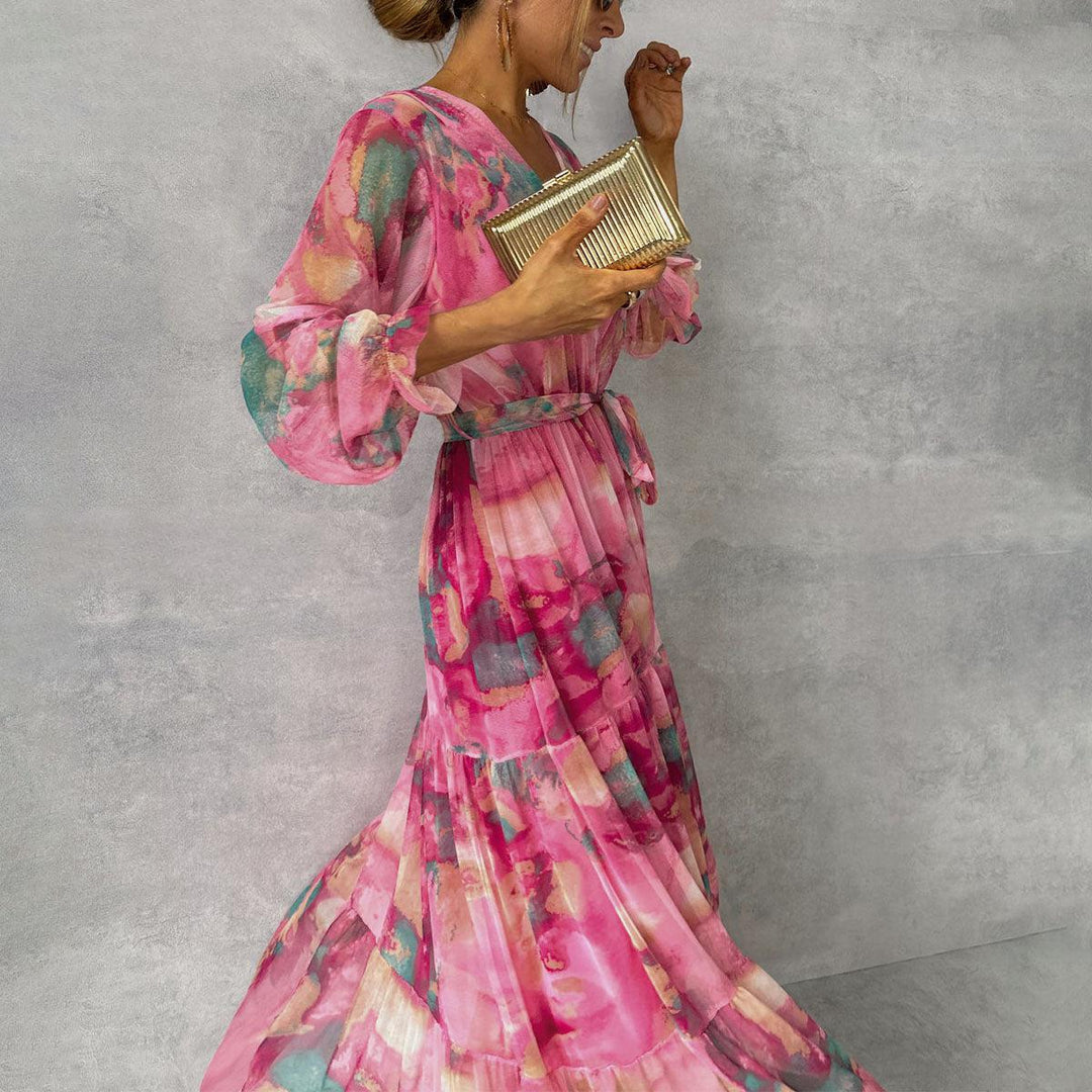 Feminine pink floral wrap maxi dress featuring elegant long sleeves. Comfortable & stylish for any special occasion.