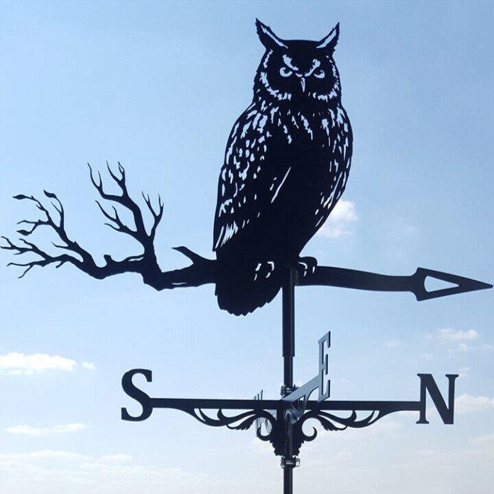 Classic wind vane in a garden, enhancing patio decor with its elegant design.