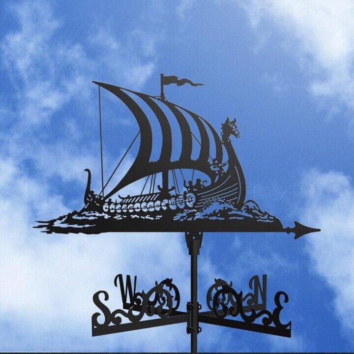 Decorative metal wind vane, an elegant yard art accent for any garden.