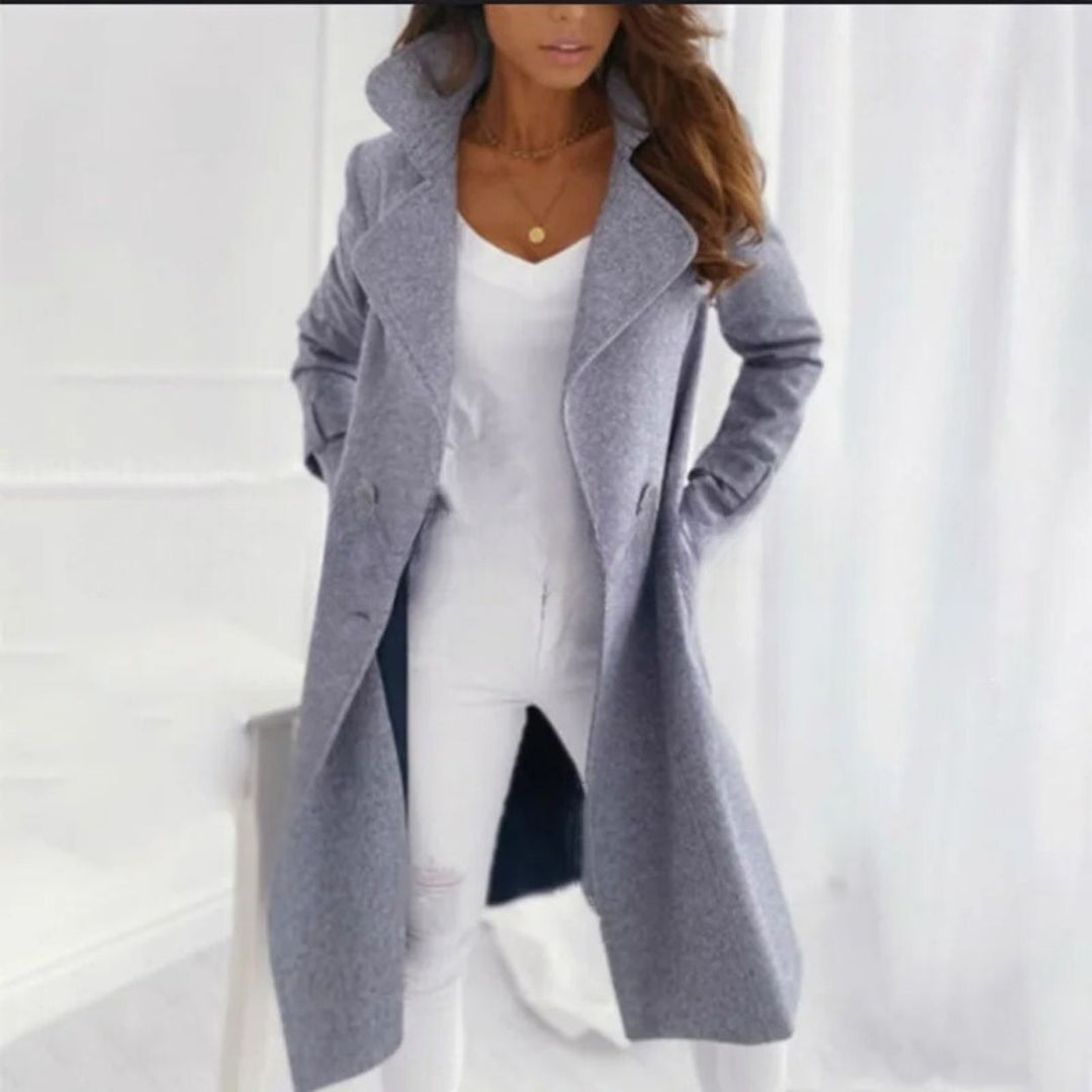 Fashionable long women's fall coat with a classic turned-down collar. Elegant winter outerwear for ladies.