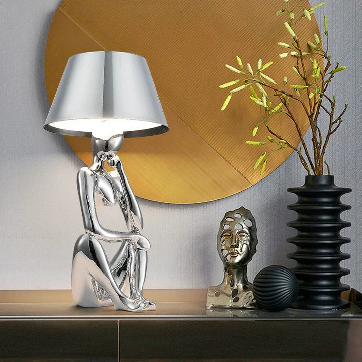 Stylish blue modern lamp providing ambient lighting for a chic bedroom.