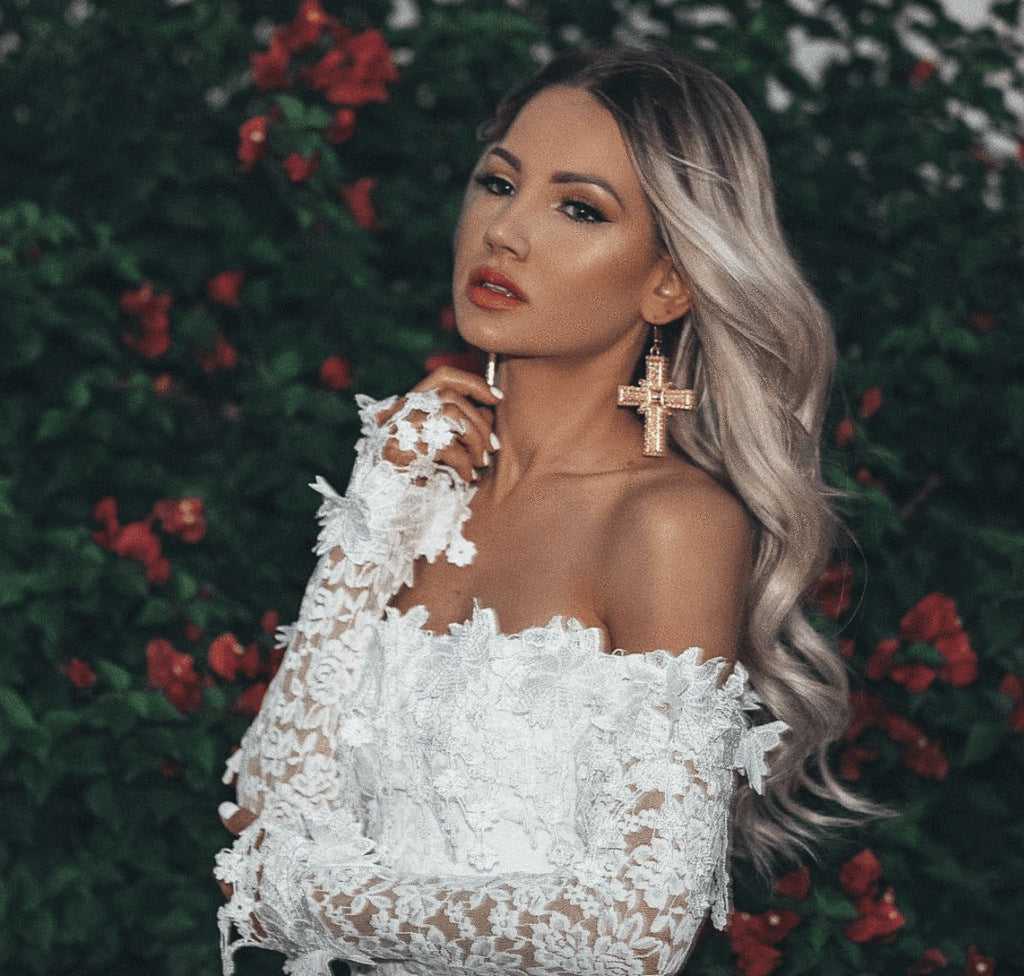 Chic women's off-shoulder mini bridal gown featuring long sleeves. Ideal for a modern wedding, reception, or special occasion.