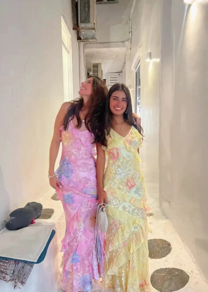 Long floral maxi dress in a sunny yellow hue, perfect for beach weddings or summer parties.
