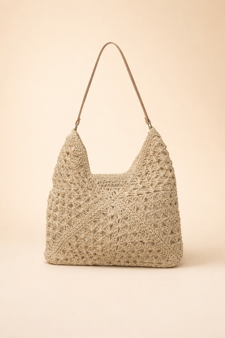 Elegant women's bohemian shoulder bag with intricate woven design. Chic accessory for relaxed styling.