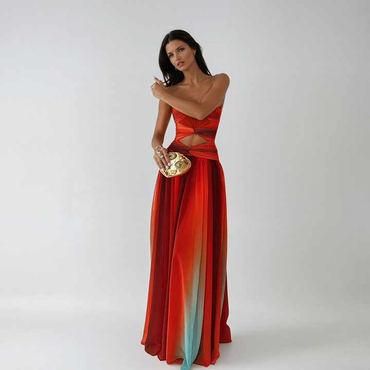 Elegant red strapless maxi dress with chic knot detail for formal occasions.