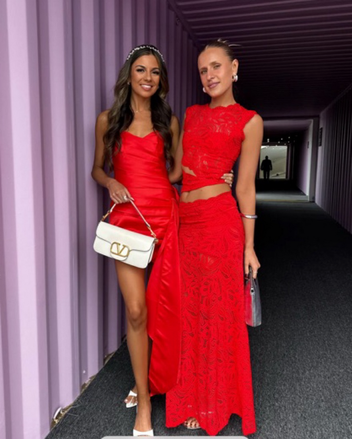Red two-piece women's elegant set, ideal for evening parties. Feminine and sophisticated statement attire.