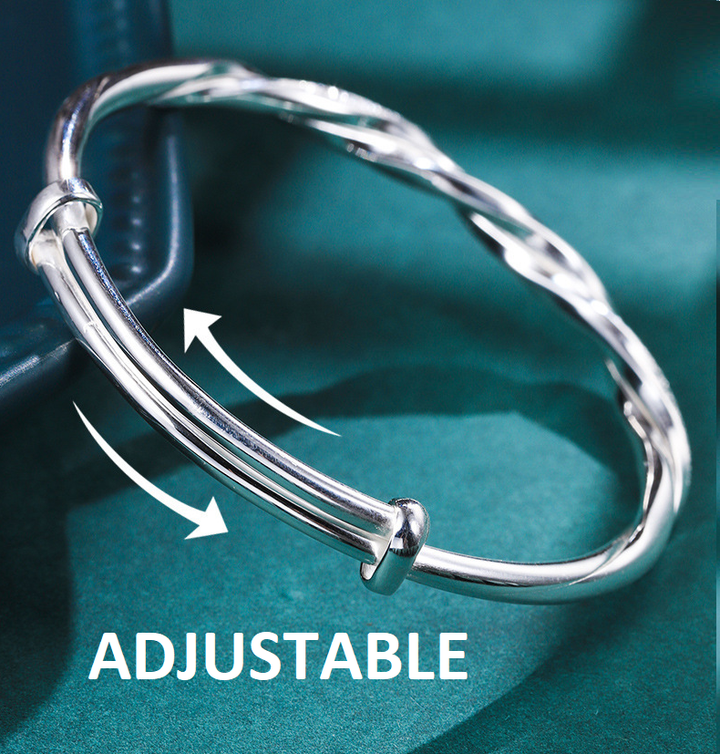 Women's elegant sterling silver bracelet with intricate design, a stylish and comfortable fashion accessory.