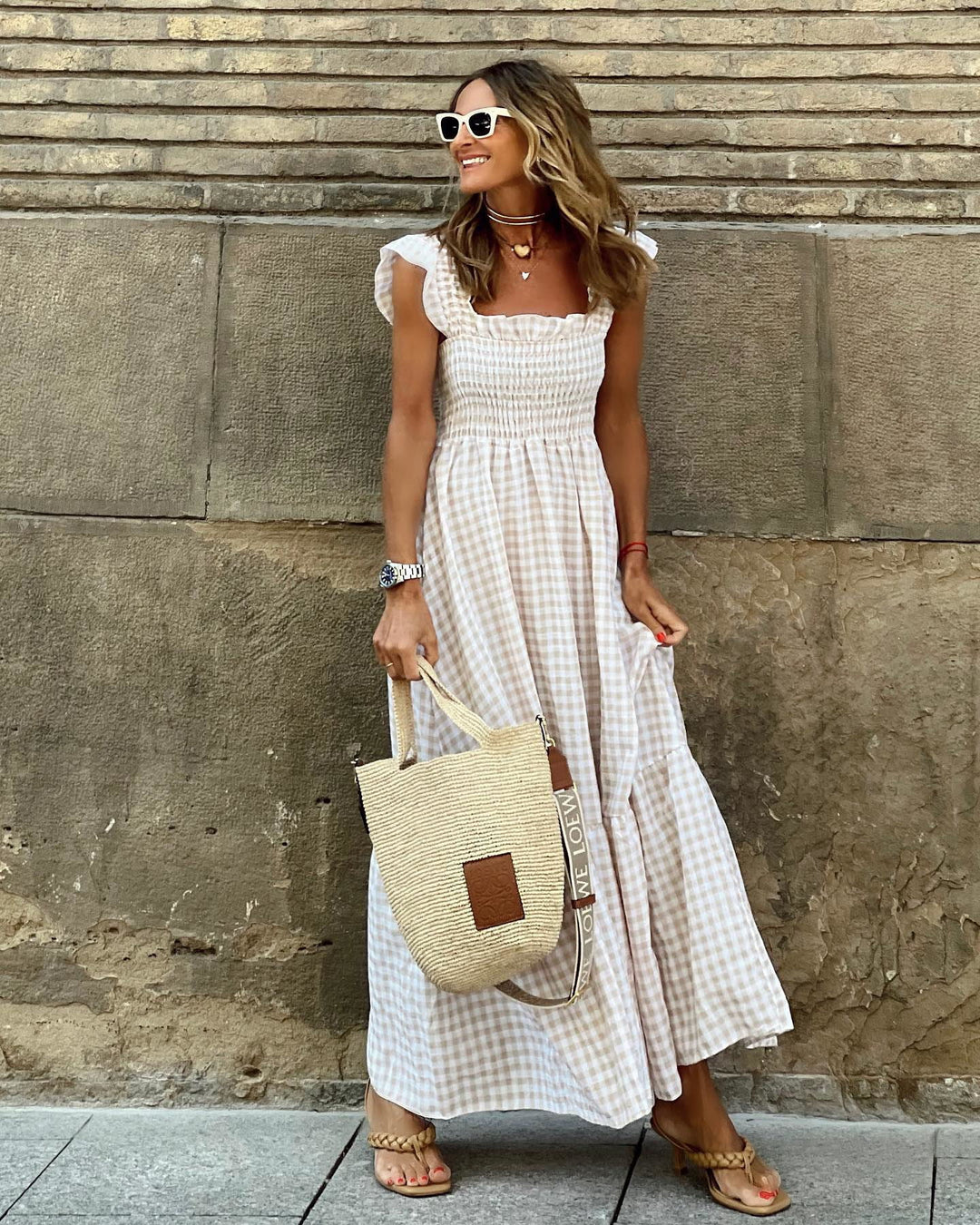 Elegant women's smocked maxi dress with ruffled sleeves. Perfect for summer fashion & occasion wear. Comfortable & flattering.