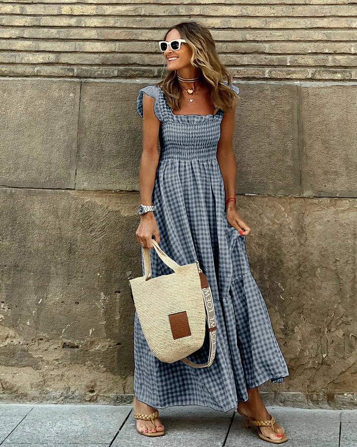 Stylish women's maxi dress with an elegant smocked bodice and delicate ruffled sleeves. A flattering long dress.