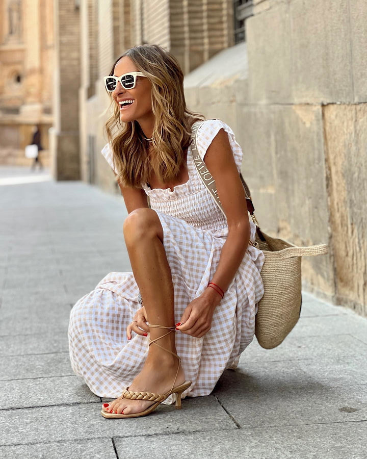 Summer fashion: comfortable women's smocked maxi dress with elegant ruffled sleeves. A flattering and stylish long dress.