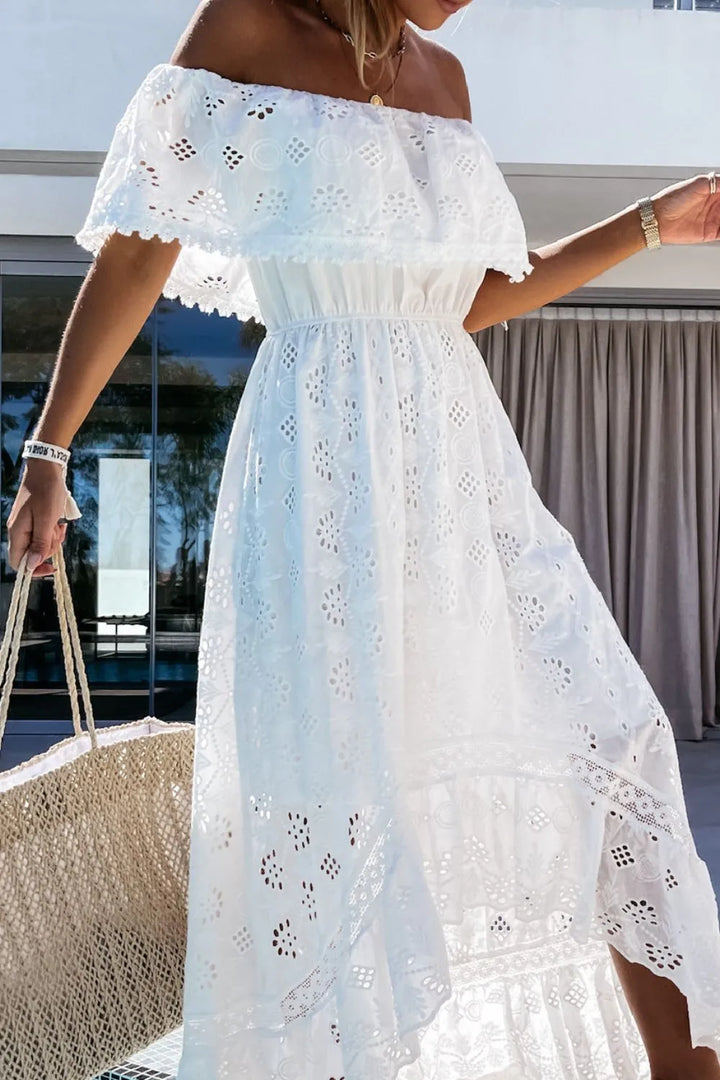 Off-shoulder white lace dress with flowing high-low skirt for summer.