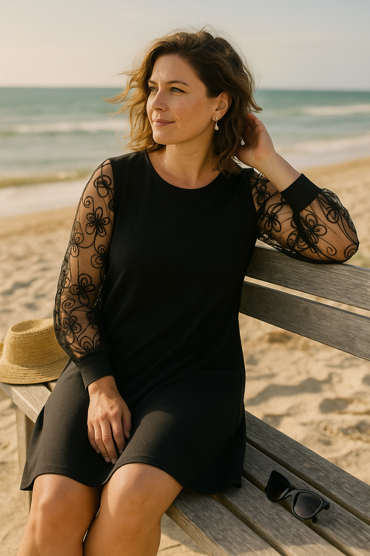 Flattering women's A-line cocktail dress featuring elegant sheer embroidered sleeves and a modest fit.