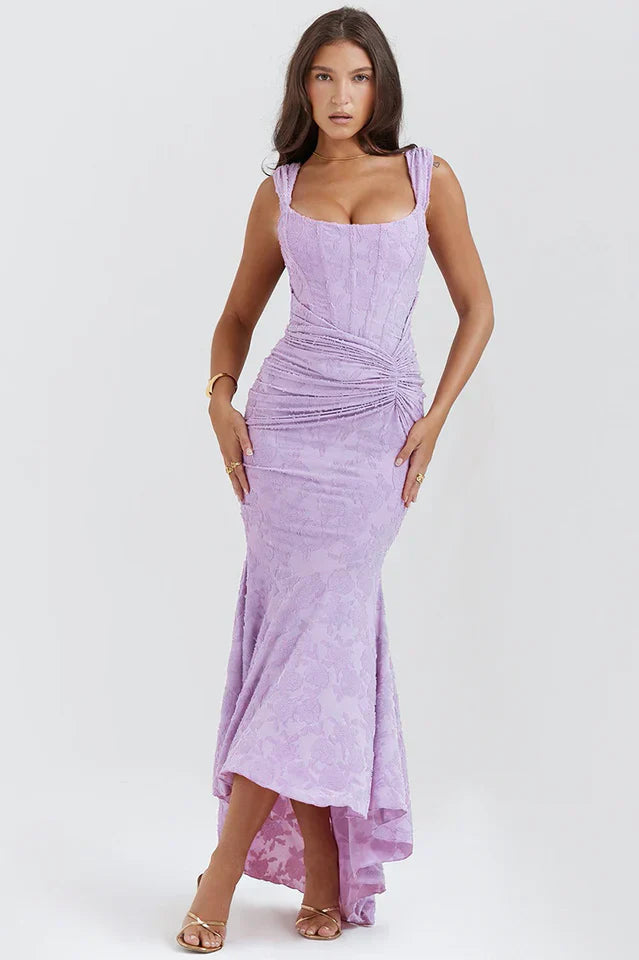 Flowing maxi hemline of an elegant women's ruched corset formal evening gown.