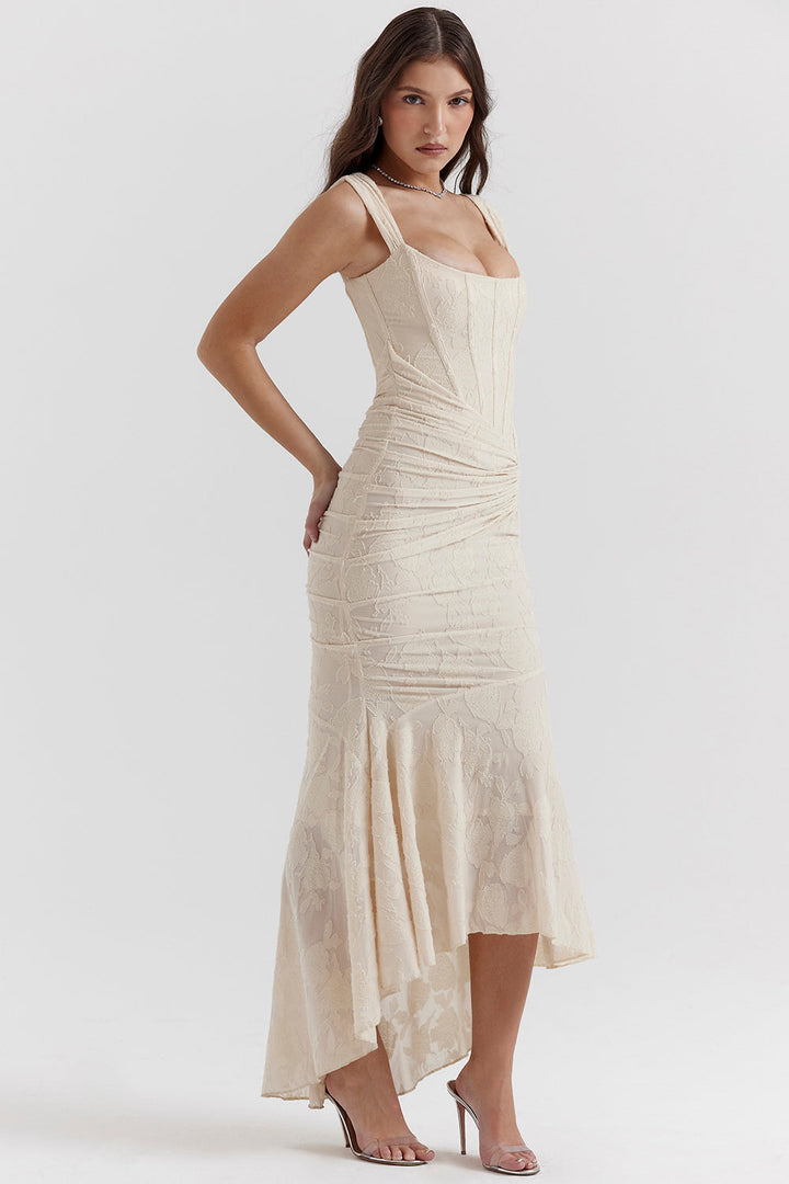 Elegant woman walking in a flowing ruched corset maxi dress, ideal for parties & occasion wear.