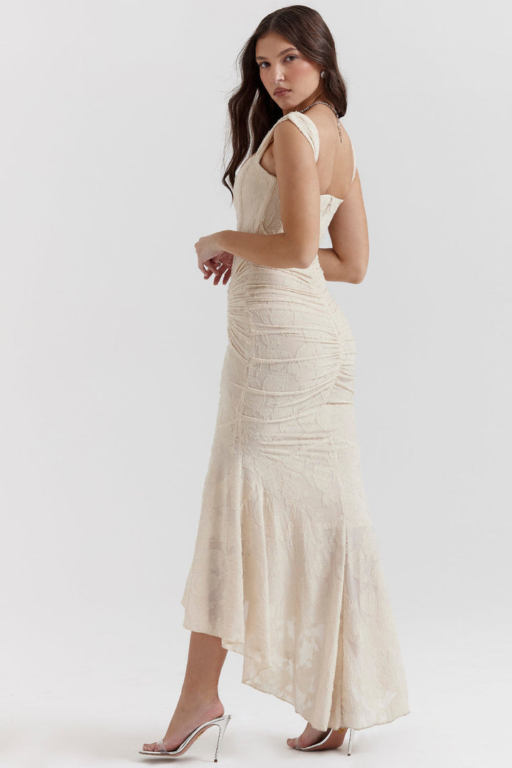 Luxurious fabric texture of an elegant women's ruched formal evening gown, maxi length dress.
