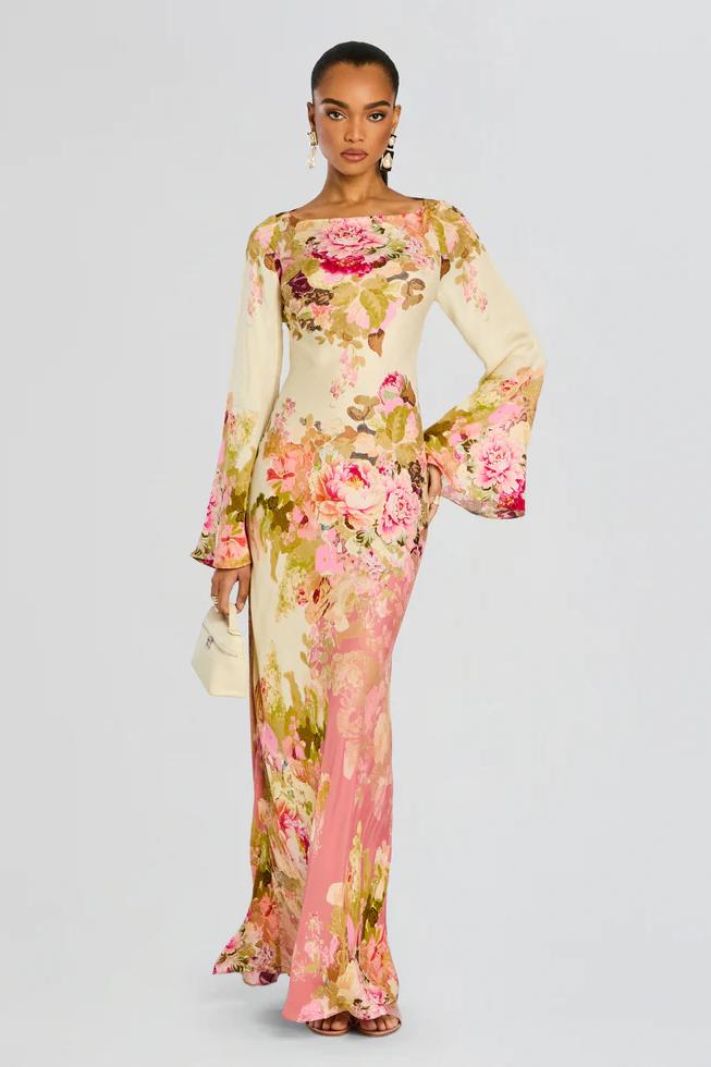 Boho-chic floral print maxi dress with dramatic bell sleeves, perfect for summer events.