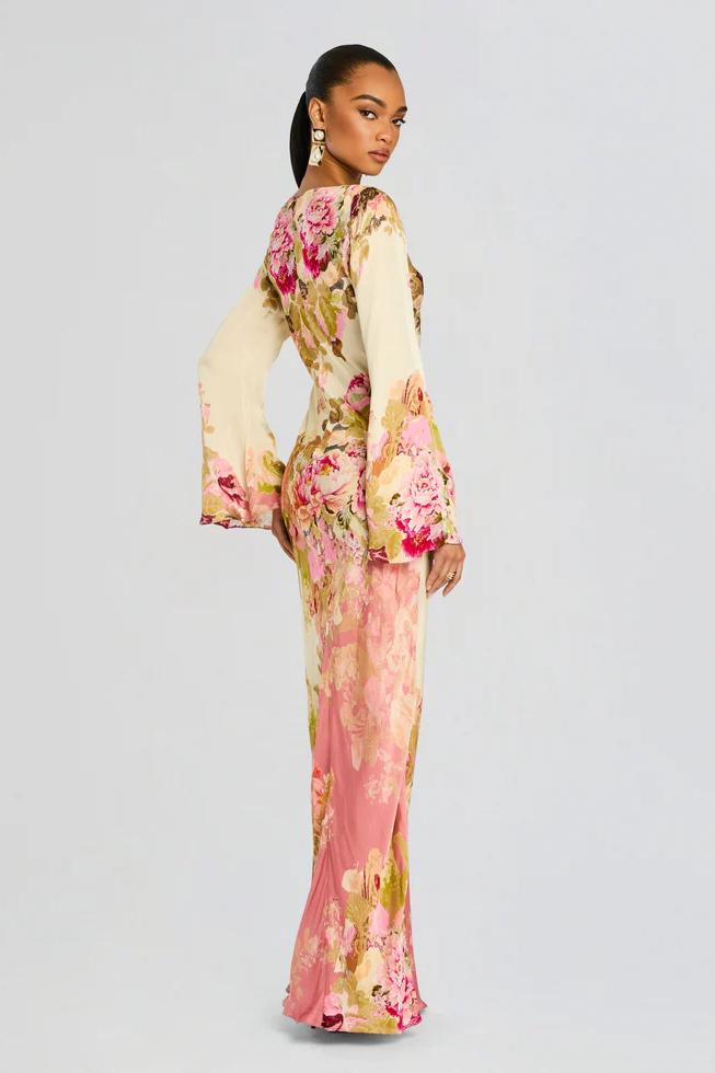 Flowy women's evening gown featuring a vibrant floral pattern and unique bell sleeves.