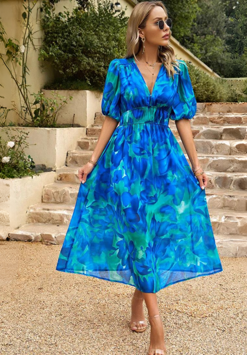 Front view of women's elegant floral midi dress, showcasing V-neckline and stylish puff sleeves.