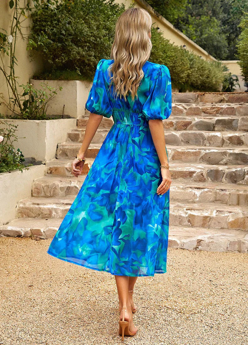 Chic women's elegant floral midi dress with a flowing silhouette and puff sleeves, great for any summer occasion.