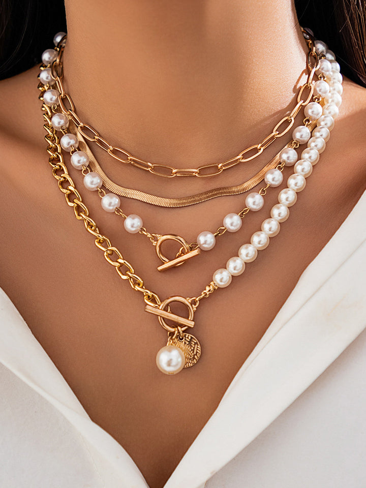 Fashionable women's gold-plated layered necklace adorned with beautiful pearls. A perfect elegant jewelry gift.