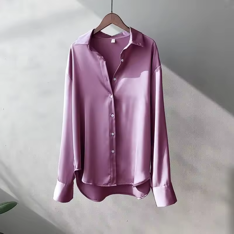 Elegant women's fashion: a flowing jade silk blouse for summer.