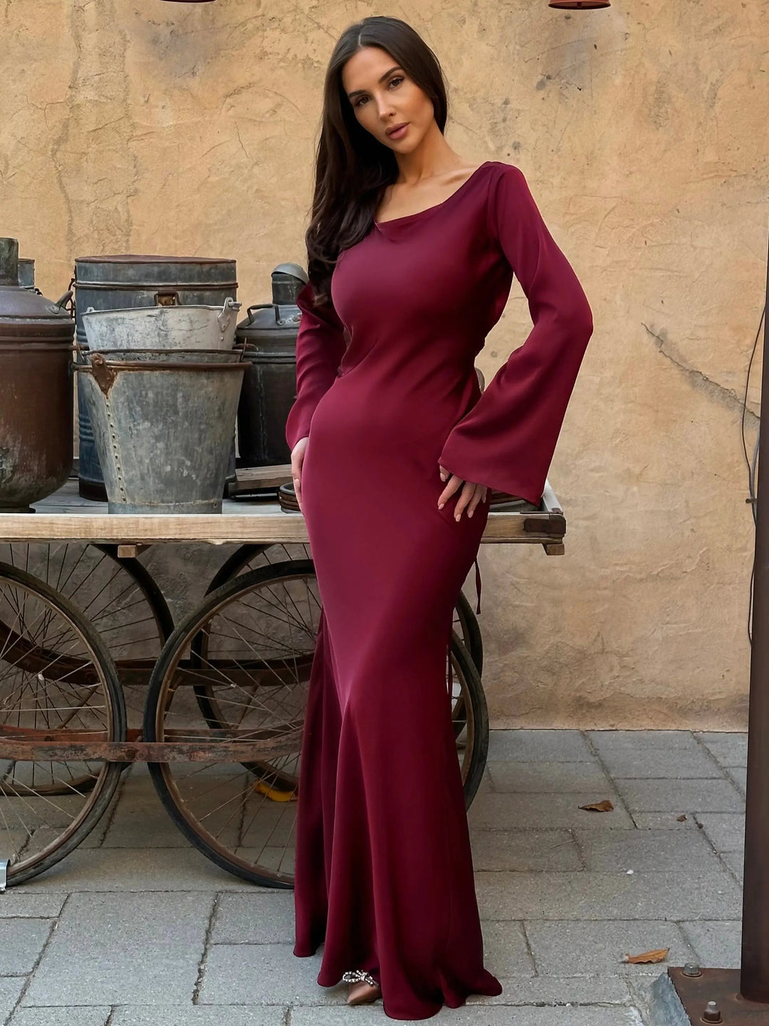 Complete look: Formal long sleeve maxi dress paired with elegant accessories.
