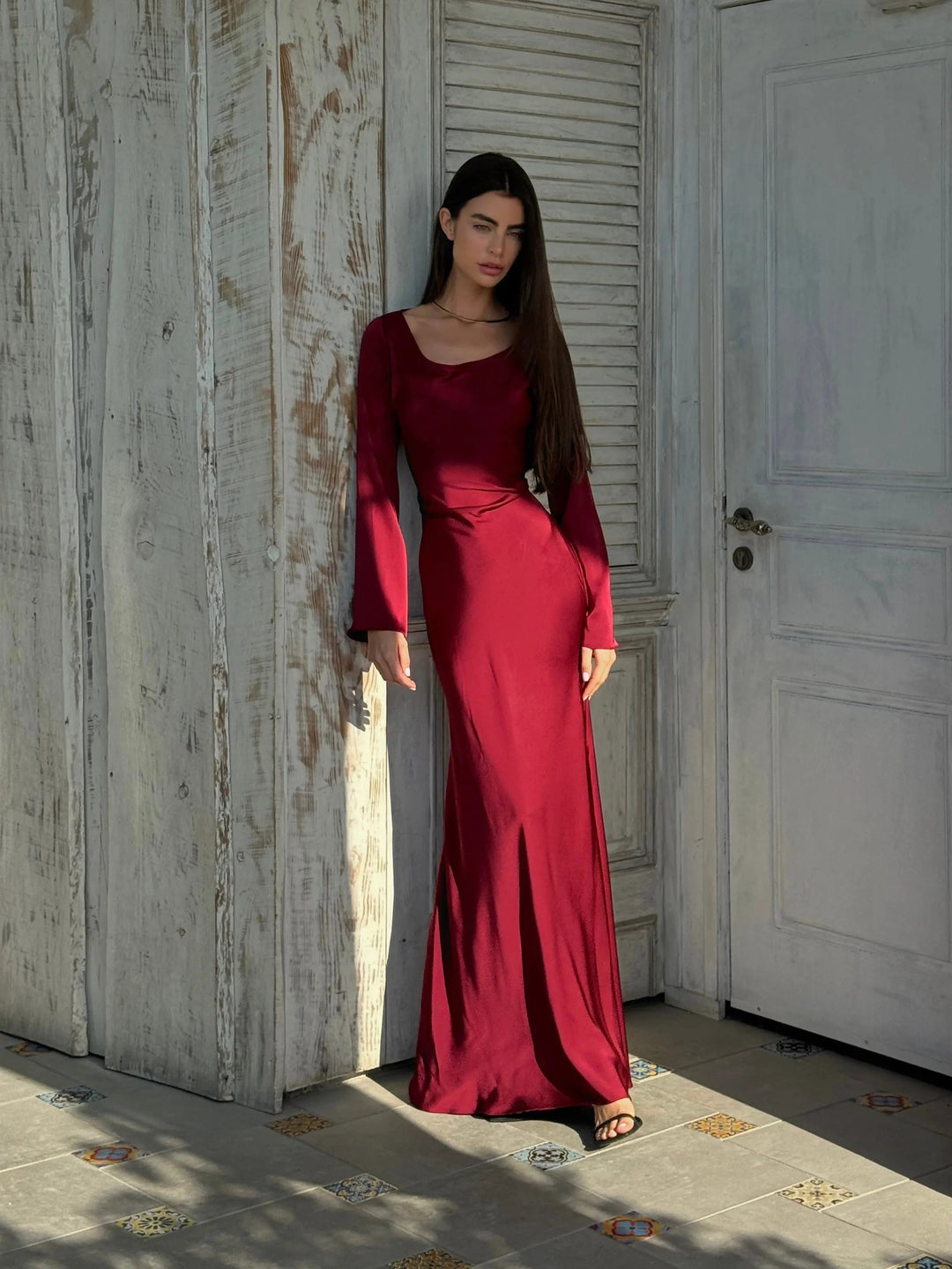Close-up on the intricate fabric of an elegant long sleeve formal maxi dress.