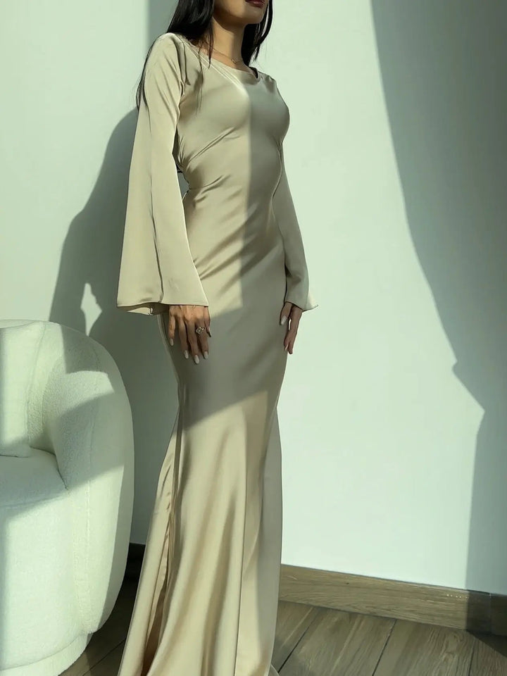 Model showcasing a sophisticated long sleeve maxi dress suitable as a wedding guest dress.