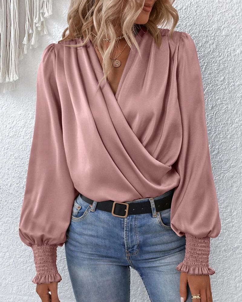 Sophisticated women's long-sleeve wrap blouse. Elegant draped top, perfect for a chic and professional look.