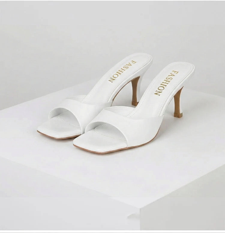 Comfortable and elegant open toe slip-on mules for women, designed with a chic square heel.