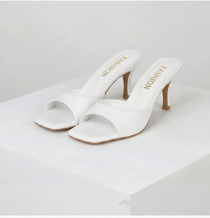 Comfortable and elegant open toe slip-on mules for women, designed with a chic square heel.