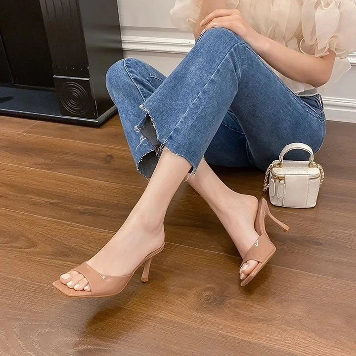 Women's open toe slip-on mules with a square heel, a versatile choice for elegant everyday wear.