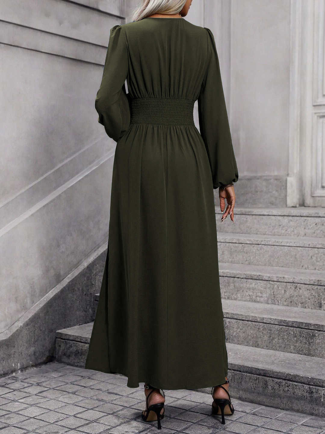 Stylish women's pink midi dress with long sleeves & a tasteful slit, perfect for wedding guest attire.