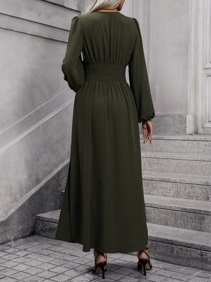 Stylish women's pink midi dress with long sleeves & a tasteful slit, perfect for wedding guest attire.
