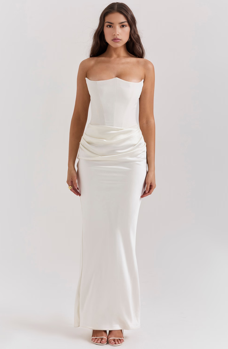 Full-length view of a women's elegant strapless corset maxi dress in motion.