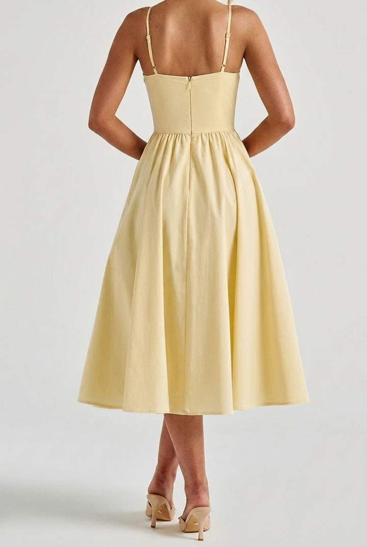 Back view of women's yellow A-line corset midi dress. Elegant spaghetti strap formal gown, perfect for special occasions.