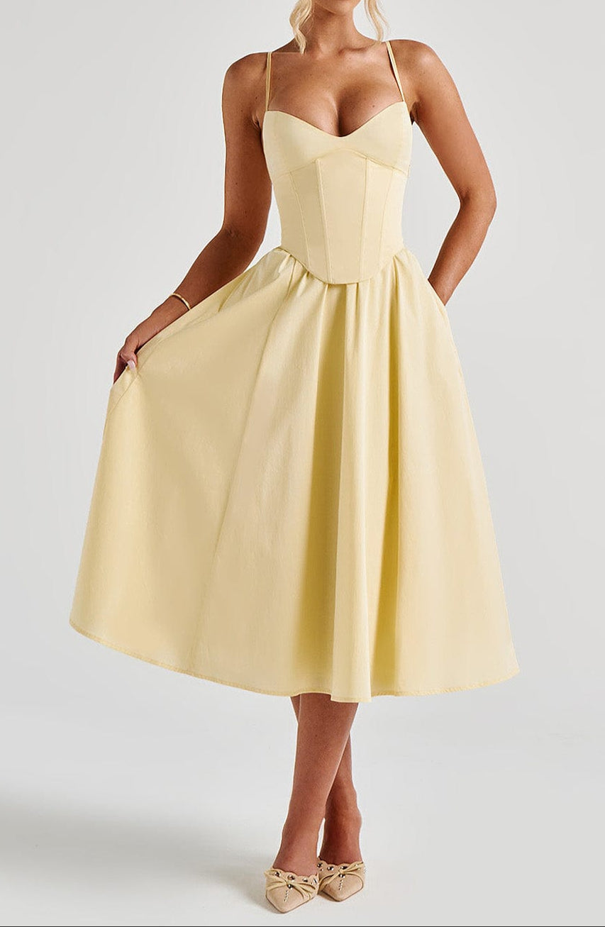 Model wearing elegant yellow A-line corset midi dress with spaghetti straps. Perfect women's formal or wedding guest dress.