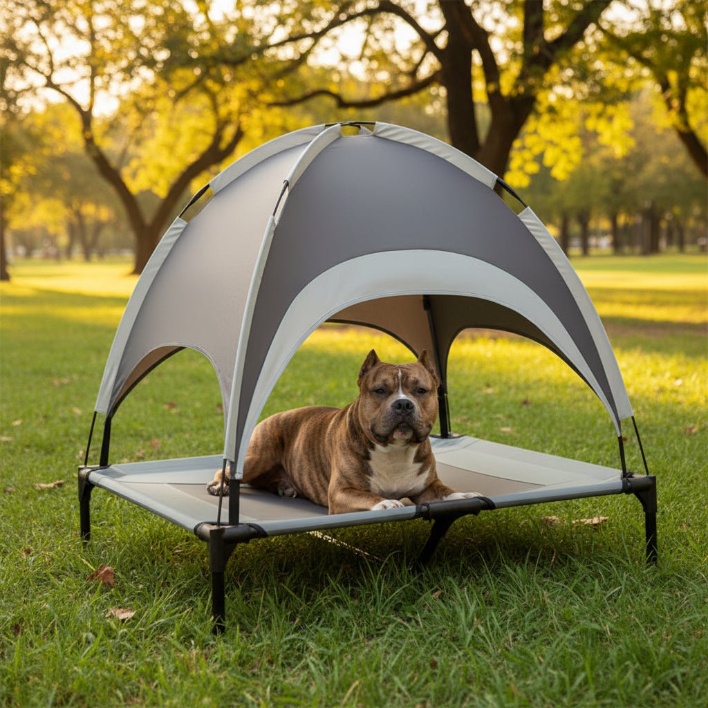 Portable elevated dog bed for outdoors, featuring a built-in cooling mat & UV protection sun shade for summer comfort.